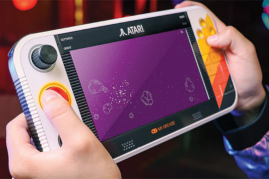 The Atari Gamestation Go being played and held in two hands.