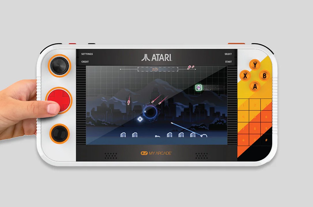 The Atari Gamestation Go handheld being held by a single hand. The Atari Gamestation Go handheld being held by a single hand.