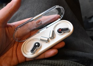 A hands-on photo of Nothing’s Ear Open earbuds.