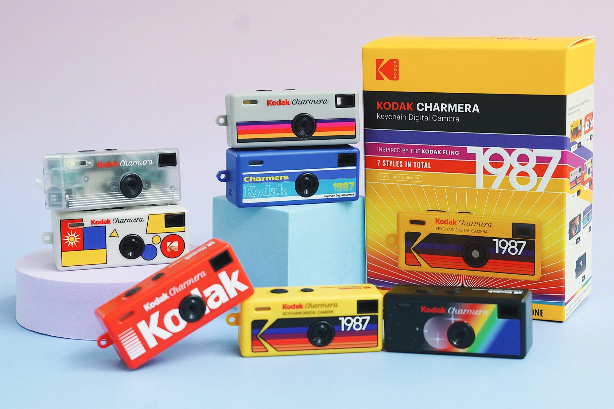 The various color options of the Kodak Charmera digital camera next to its packaging.