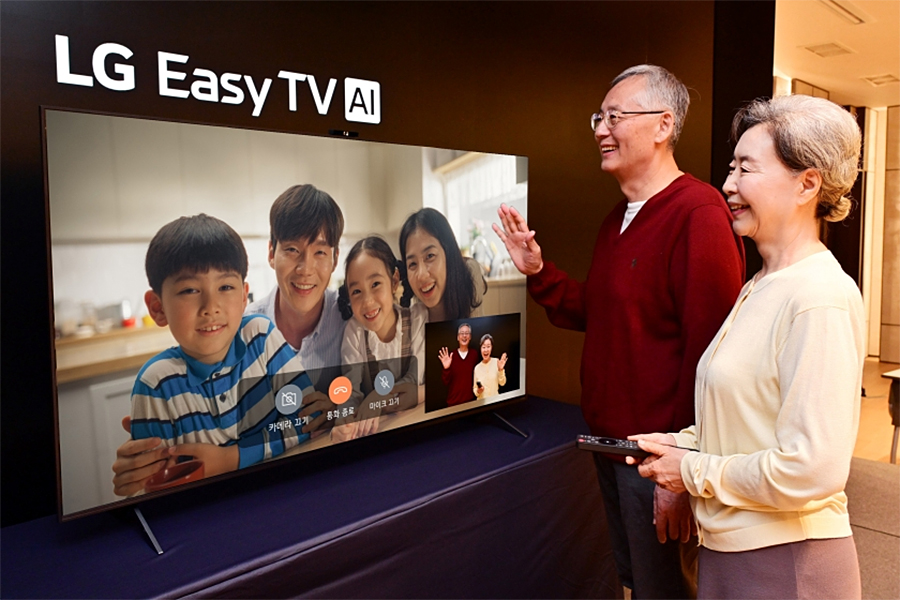 Two seniors talking to family on a video call made through the LG Easy TV.
