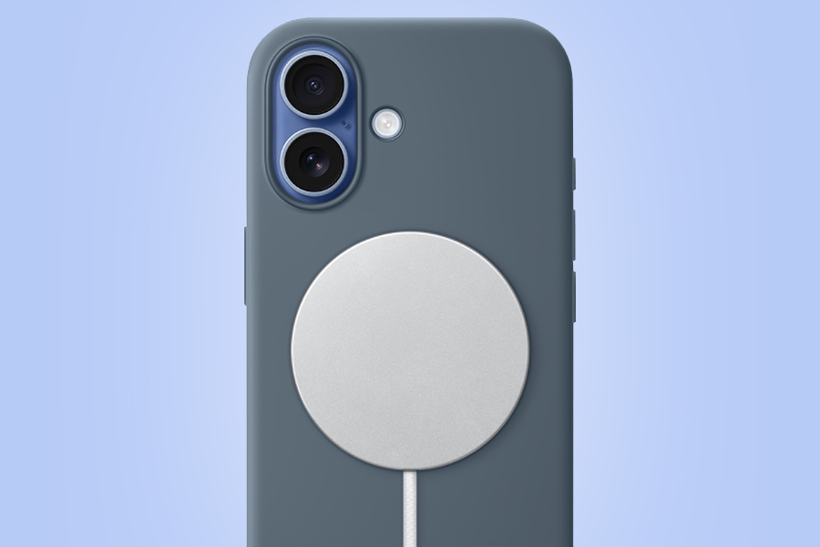 A wireless charging puck attached to the back of an Apple iPhone.