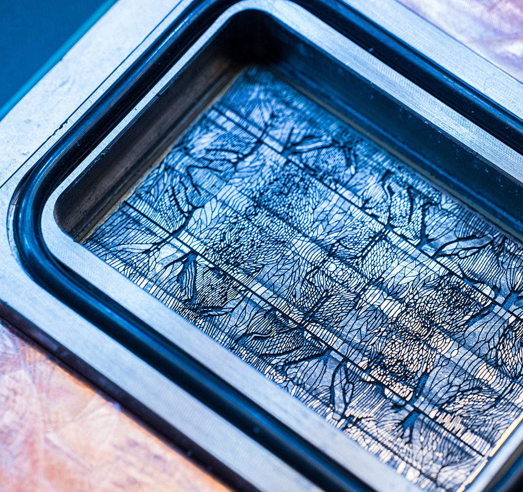 A close-up of a microchip, which is covered in intricate lines.