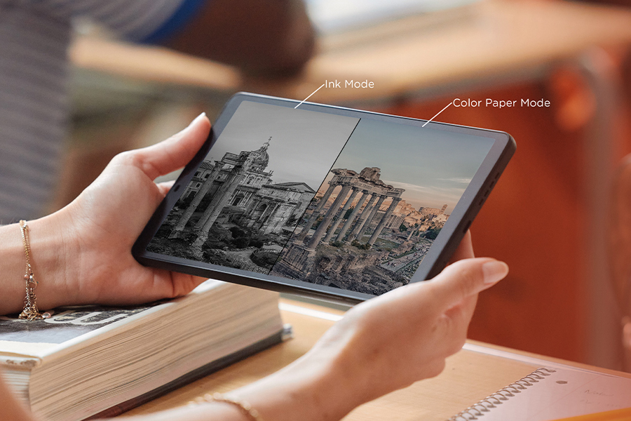 A person holding the TCL Tab 8 Nxtpaper tablet with two different color modes visible on screen.