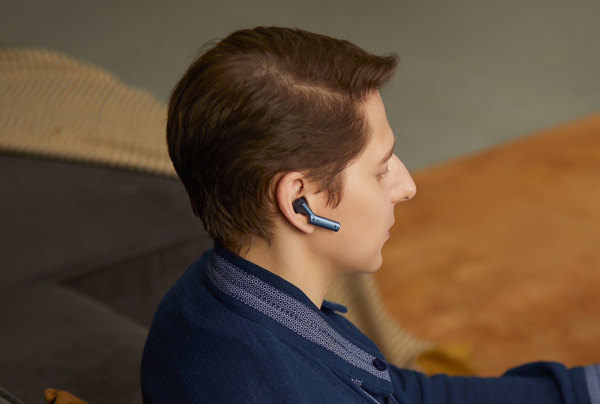 A person wearing one of the Timekettle W4 AI wireless earbuds in their right ear. A person wearing one of the Timekettle W4 AI wireless earbuds in their right ear.
