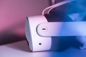 A side view of a white Meta Quest 3S headset. In the center is a a USB-C charging port with a white oval around it.