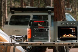 Jackery's Explorer 1000 v2 power station on a table next to a drone and countertop oven.