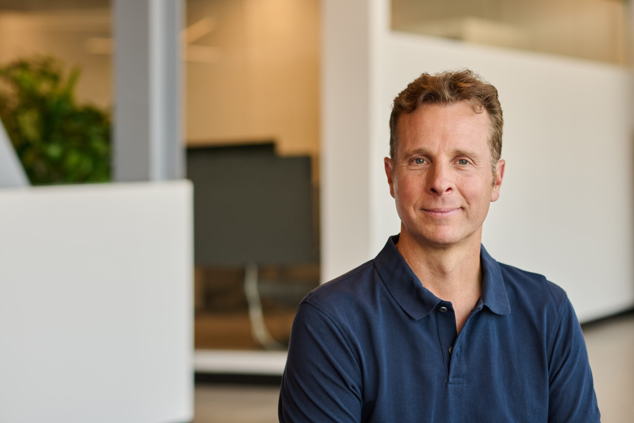 A headshot of a man in a living room.