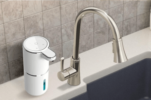 Soap dispenser next to faucet.