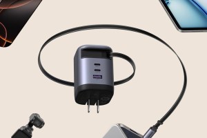 Ugreen's Nexode Charger (100W, 3-Port) surrounded by gadgets.