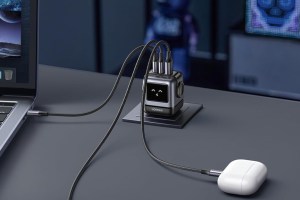 Ugreen's Uno Charger (65W, 3-Port) connected to AirPods and a MacBook.