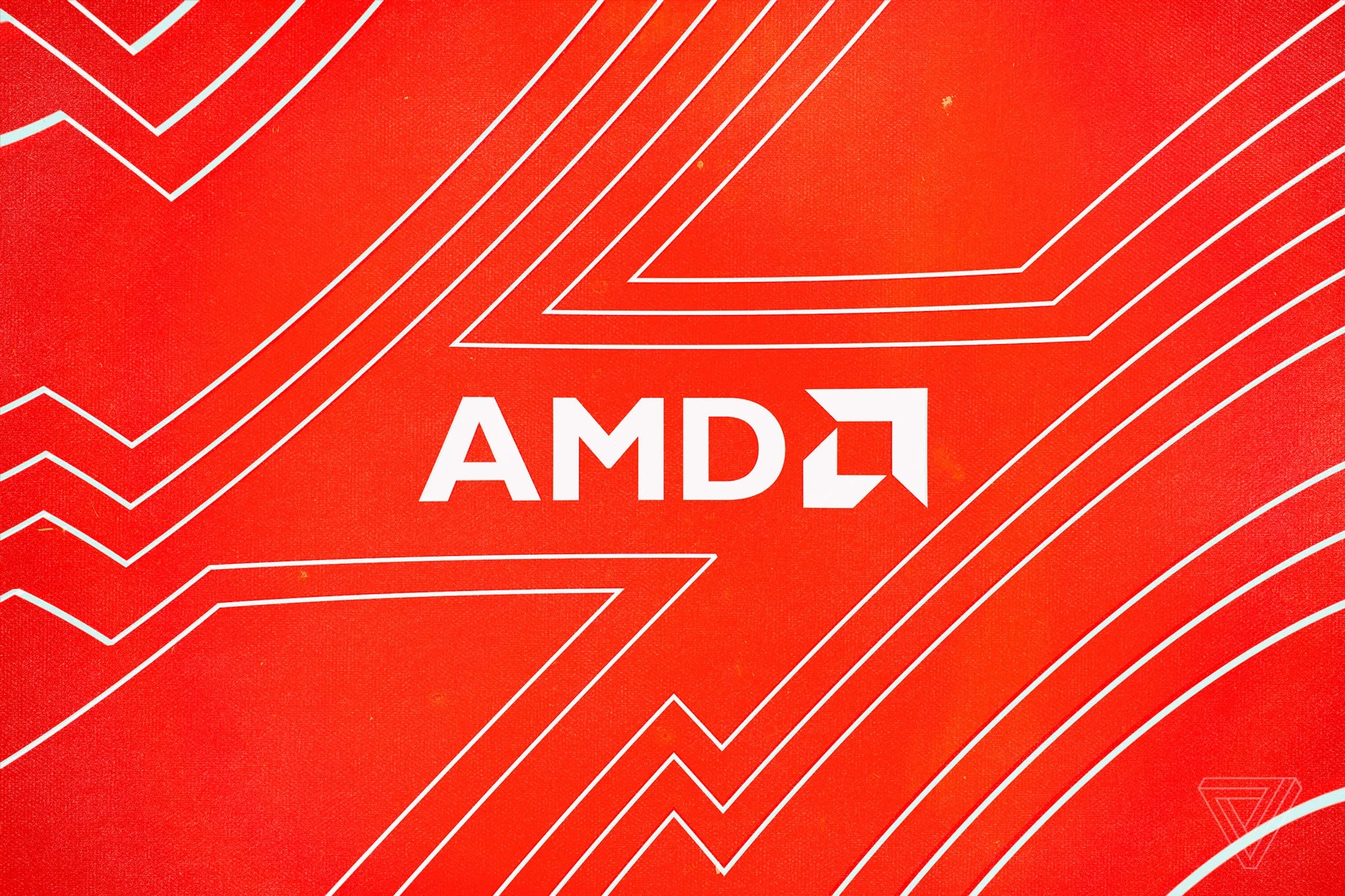 The AMD logo against a red background.
