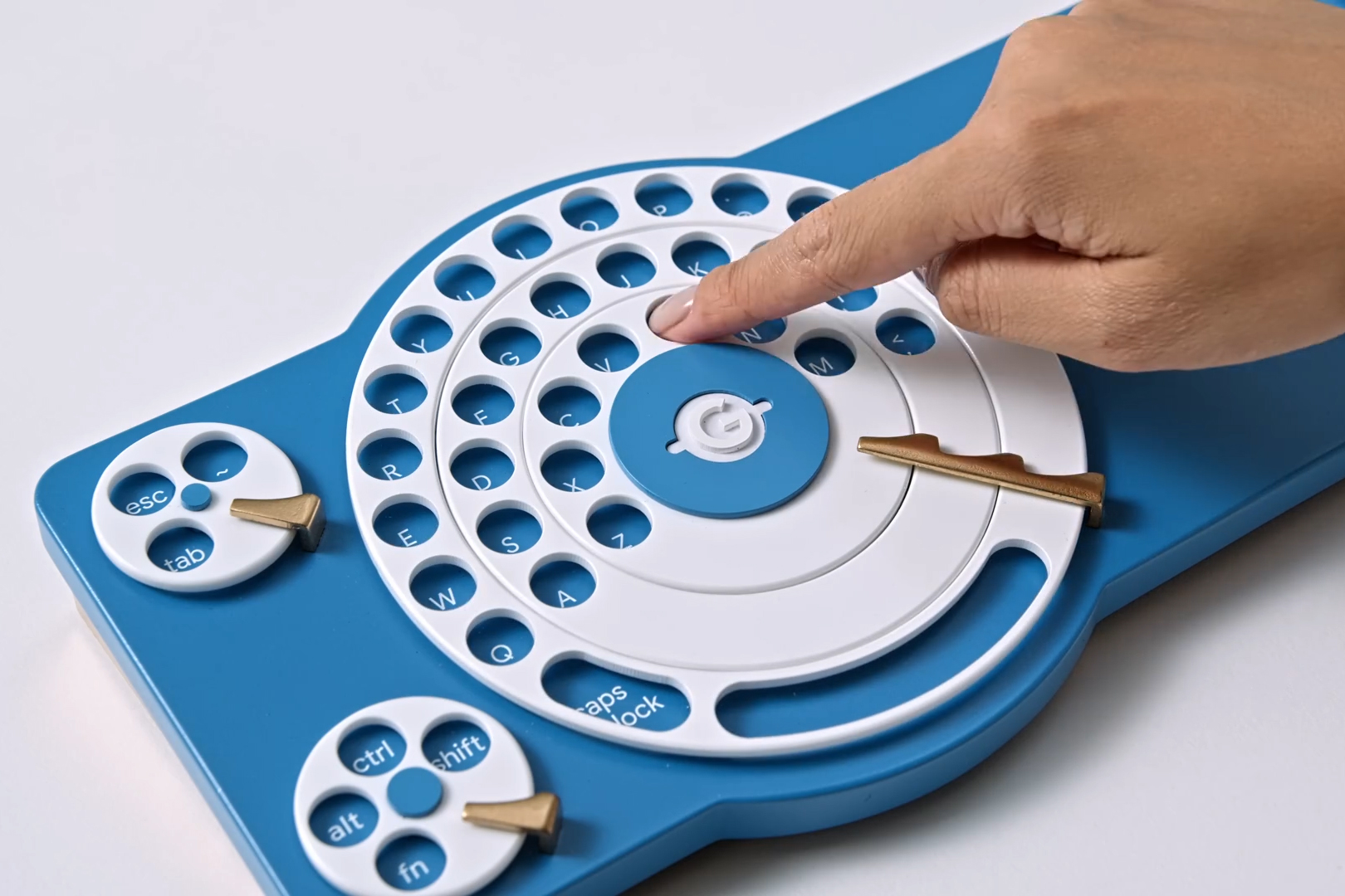 A person using their finger to turn a dial on Google Japan’s concept keyboard.
