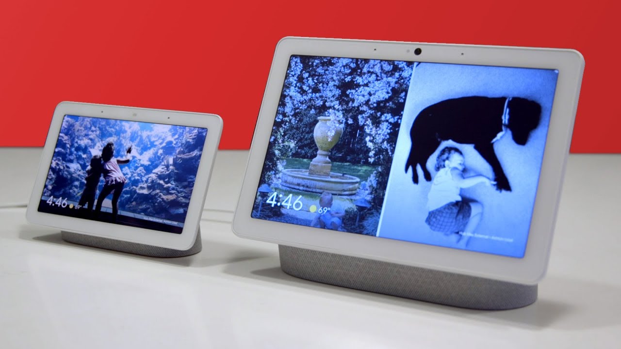 Two smart displays on a table with a red background.