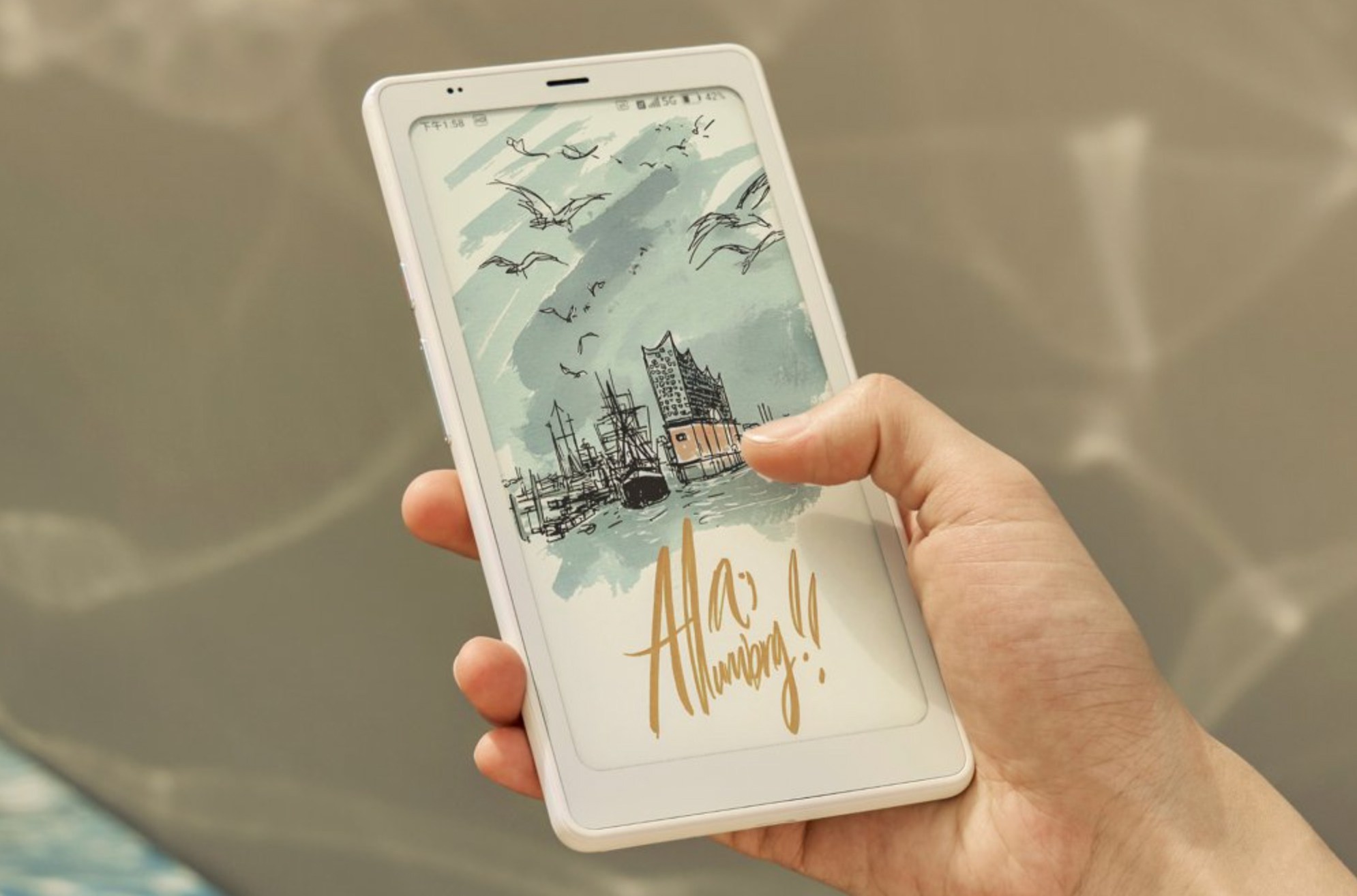 A person holding the Boox P6 Pro e-reader in one hand with a color image on screen.