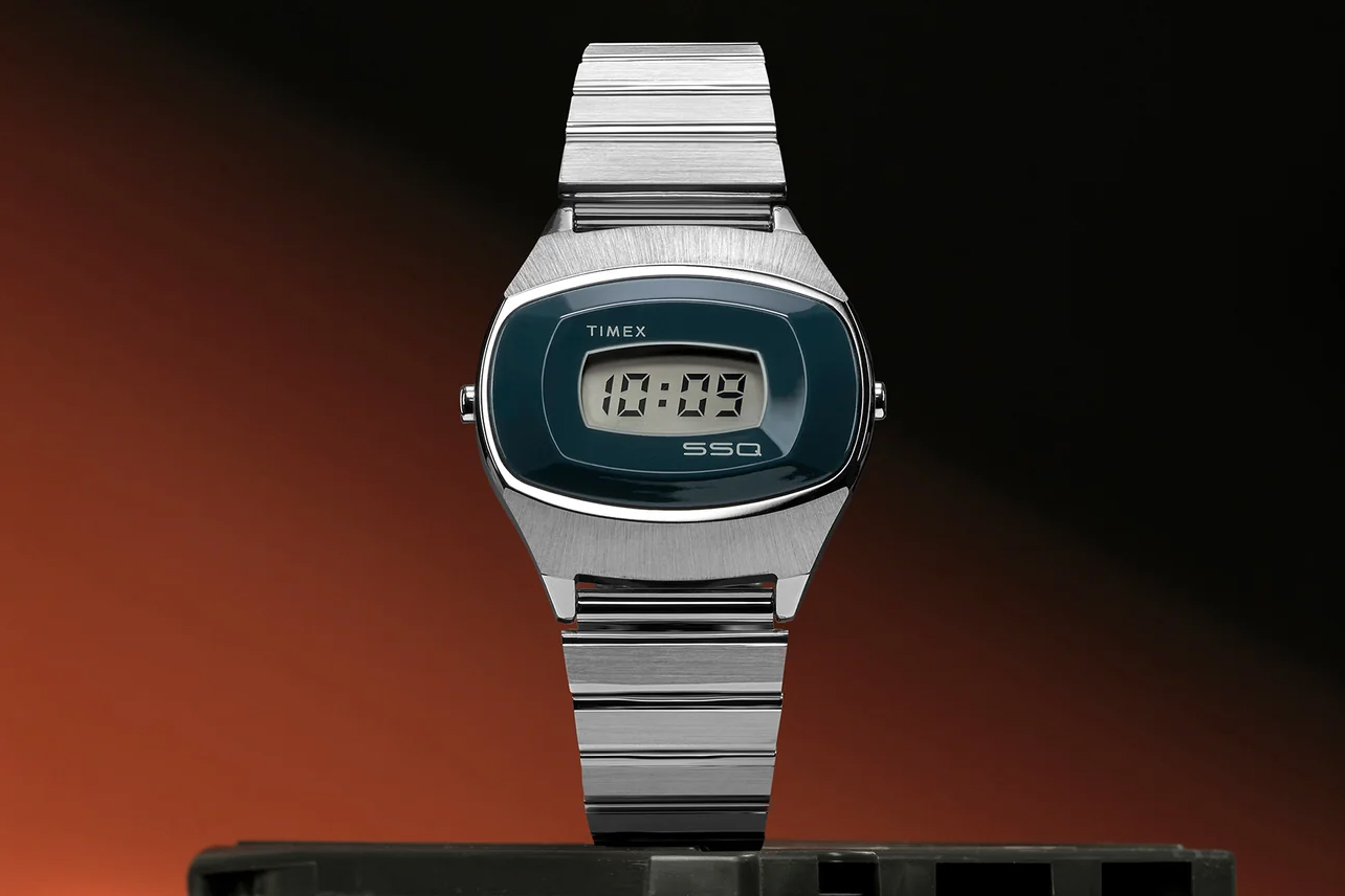 The Timex SSQ Digital Reissue watch on a stack of 8-track tapes.