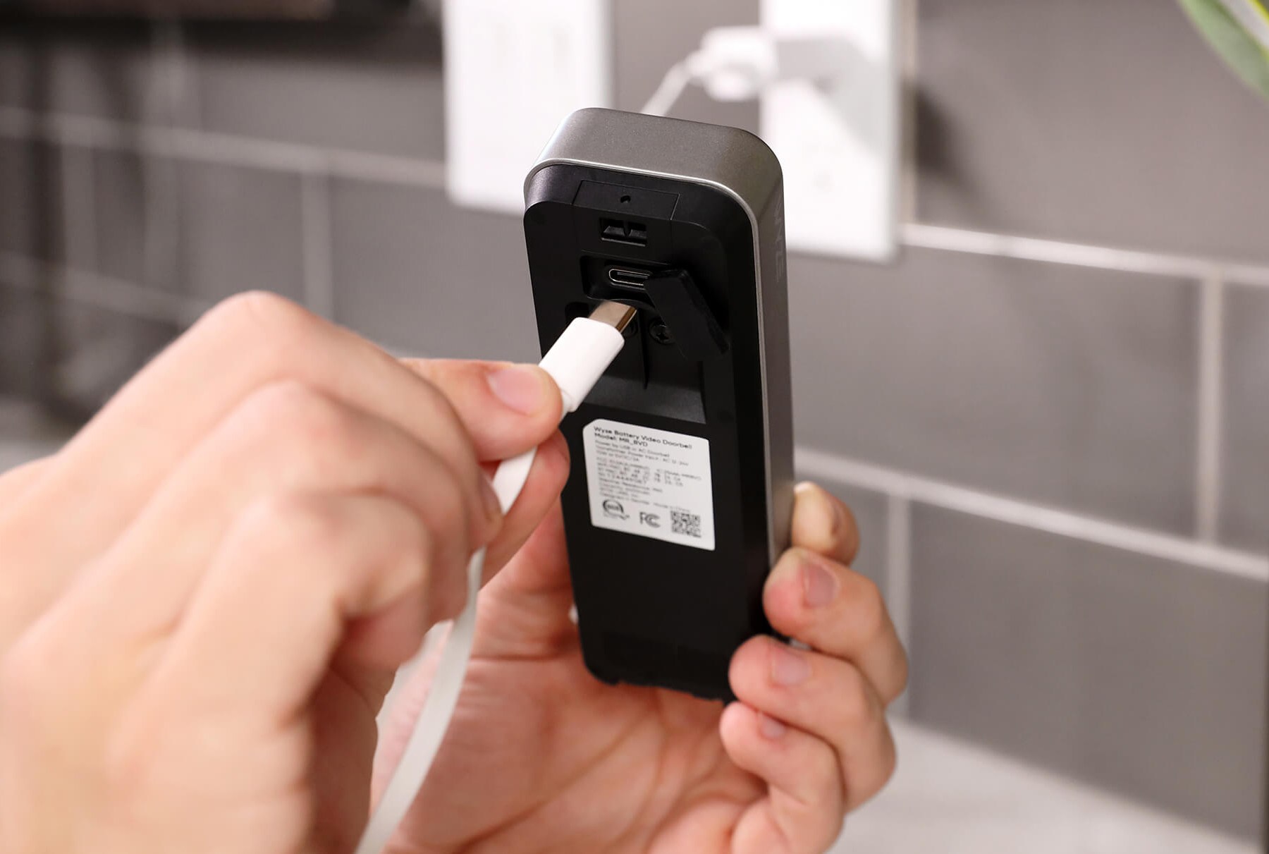 A USB-C cable being plugged into the back of Wyze’s new battery-powered doorbell camera.