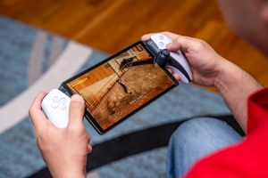 A person holding the PlayStation Portal and playing Tony Hawk’s Pro Skater 1 + 2 on it via Remote Play.