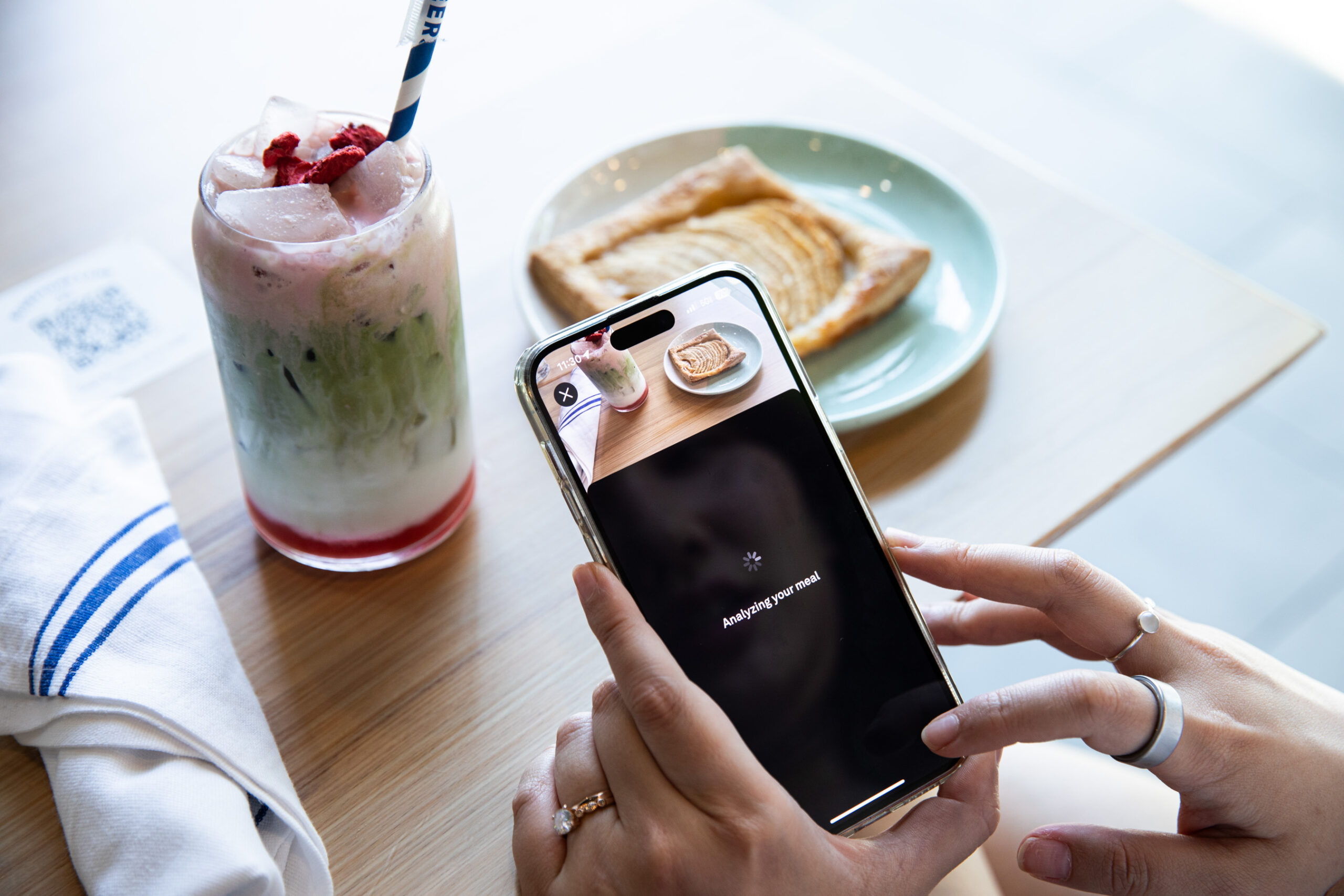 Top-down view of Oura Advisor app “analyzing” a meal of a matcha latte and apple tart