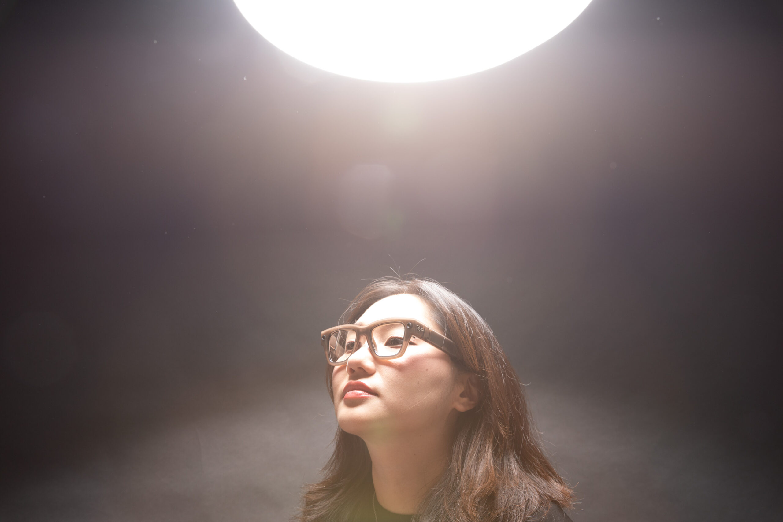 A light shining down on Senior Reviewer Victoria Song while wearing the Meta Ray-Ban Display glasses