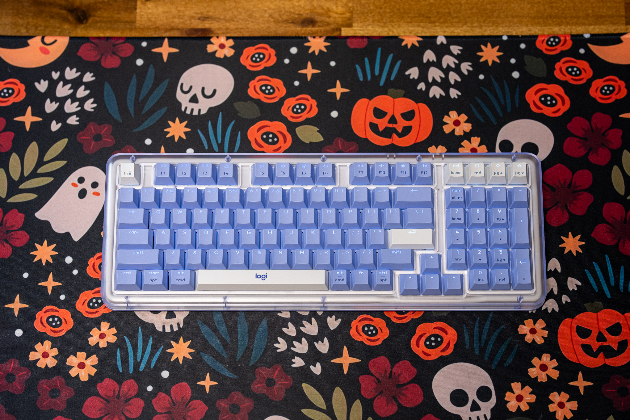 A Logitech Alto Keys K98M keyboard on a spooky-themed desk mat.