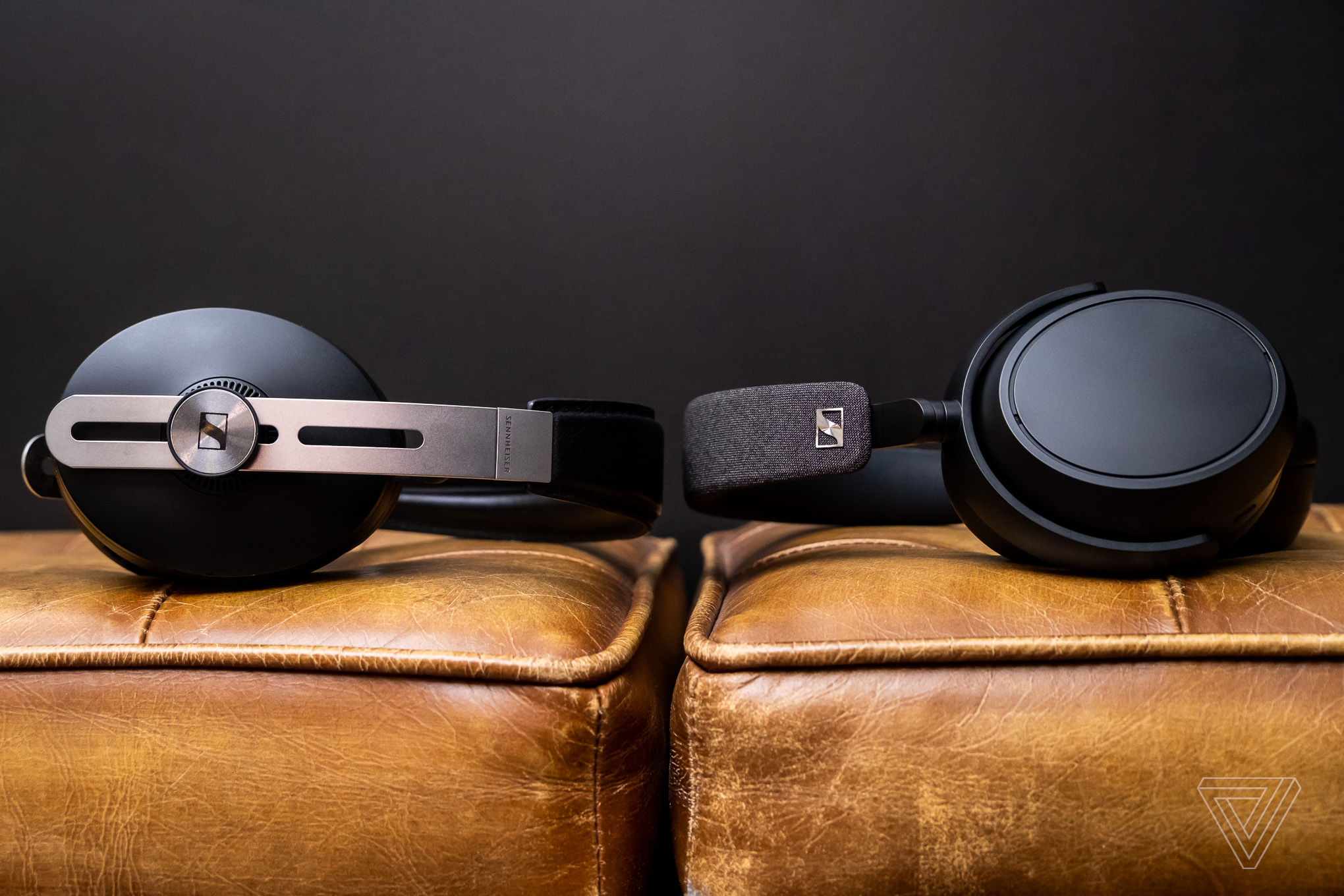 The Sennheiser Momentum 3 and Sennheiser Momentum 4 headphones facing each other while lying on a couch. The Sennheiser Momentum 3 and Sennheiser Momentum 4 headphones facing each other while lying on a couch.