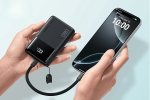 Someone holding the Iniu Pocket Rocket P50 power bank while it's connected to a phone.