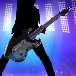 PDP's Riffmaster Wireless Guitar Accessory being held by someone on a stage.