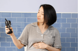 A woman holding a portable bidet.