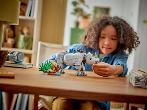 Child playing with lego rhino