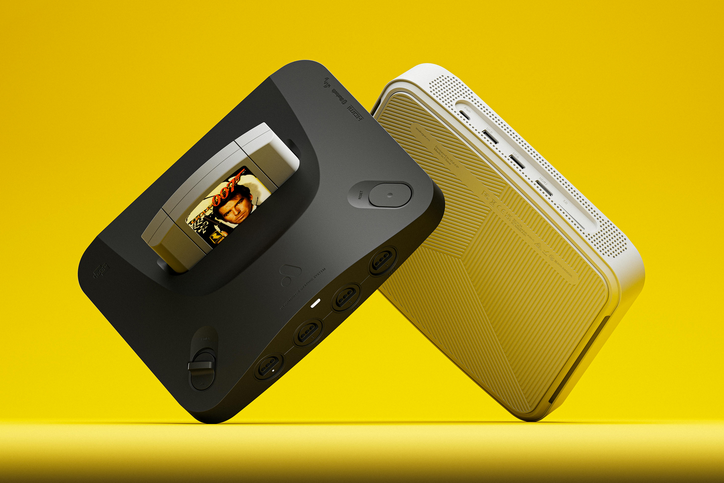 The Analogue 3D in black and white against a yellow background with a Goldeneye 007 cartridge inserted.