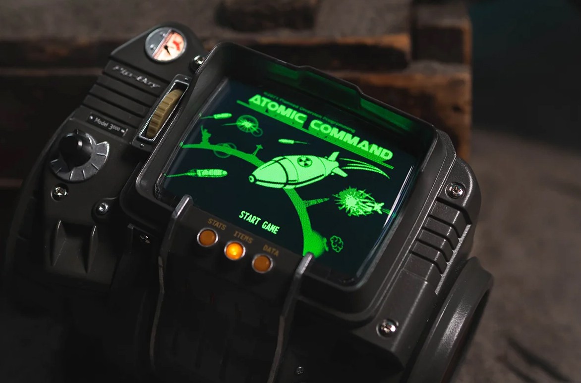 Bethesda’s replica Fallout Pip-Boy 3000 wearable showing the Atomic Command game on screen.