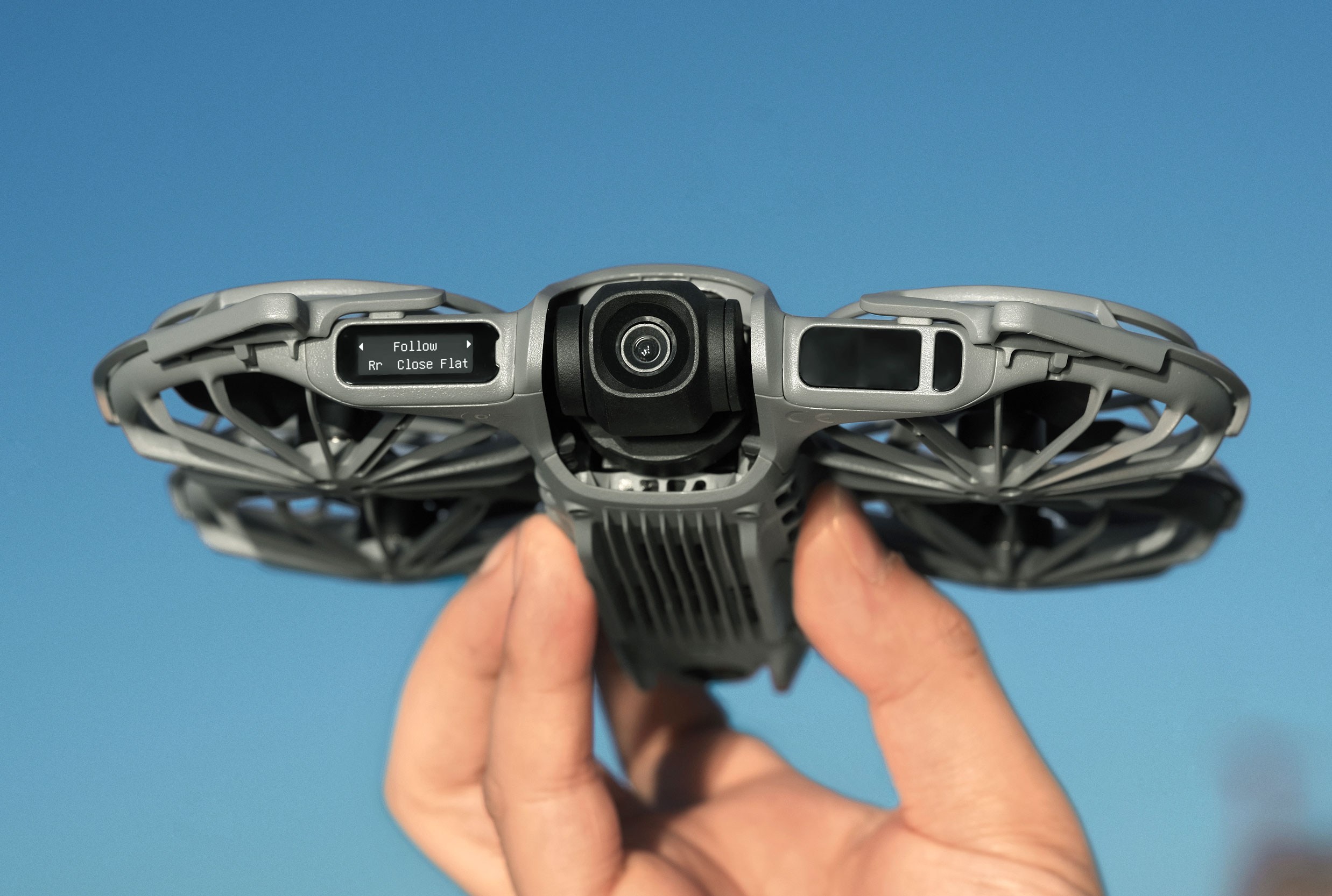 A close-up of the front of the DJI Neo 2 selfie drone while a person holds it.