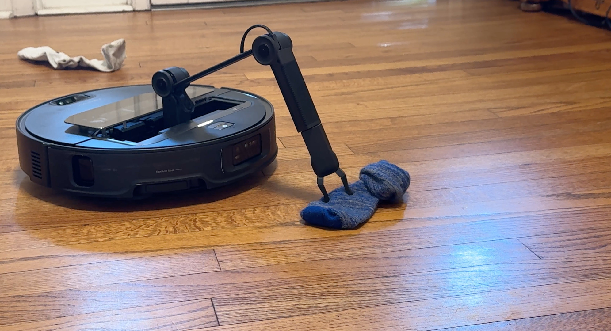 The Roborock Saros Z70 picking up a sock.