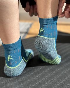 bottom of legs showing off blue socks