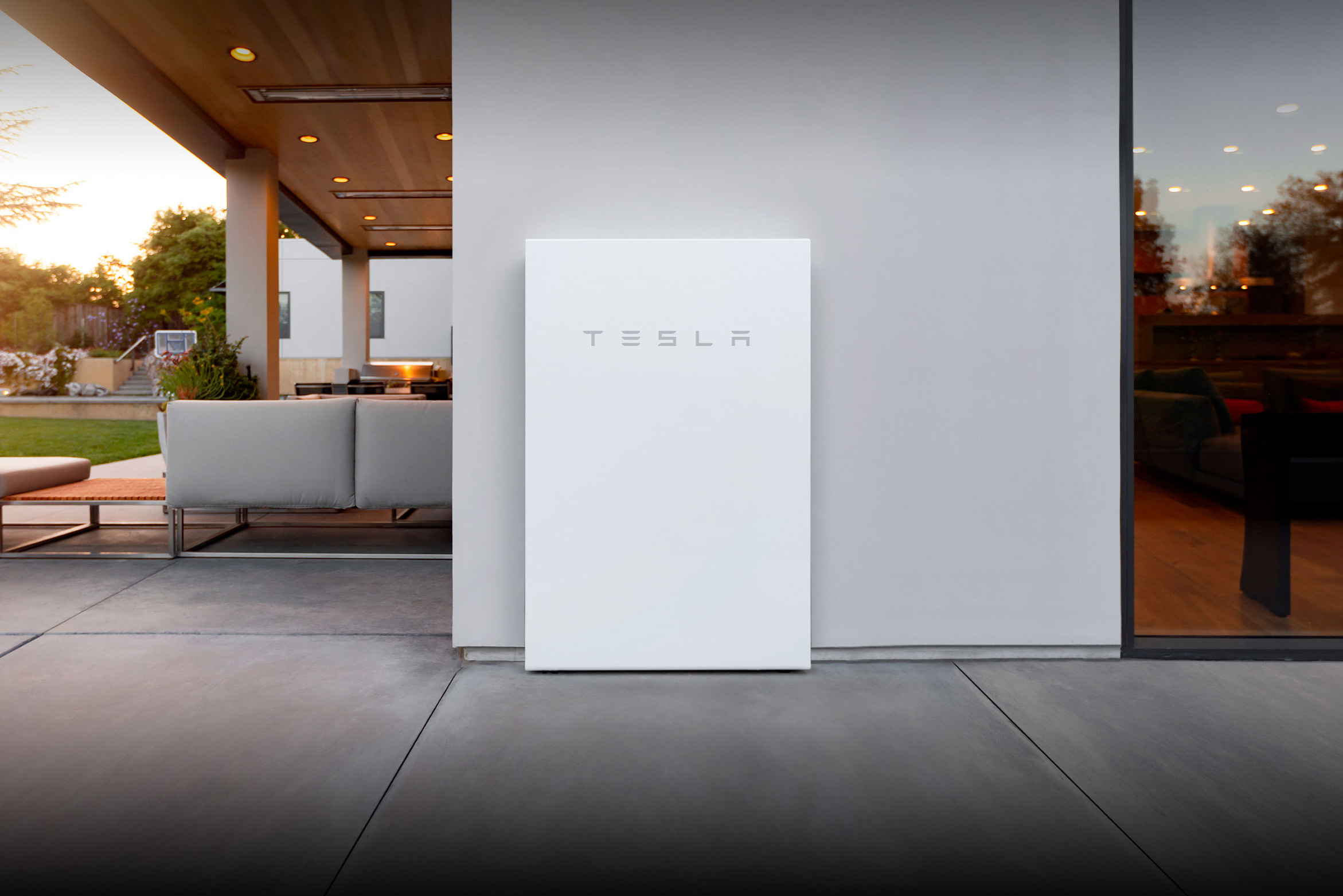 A Tesla Powerwall 2 battery unit installed on an outside wall of a home.