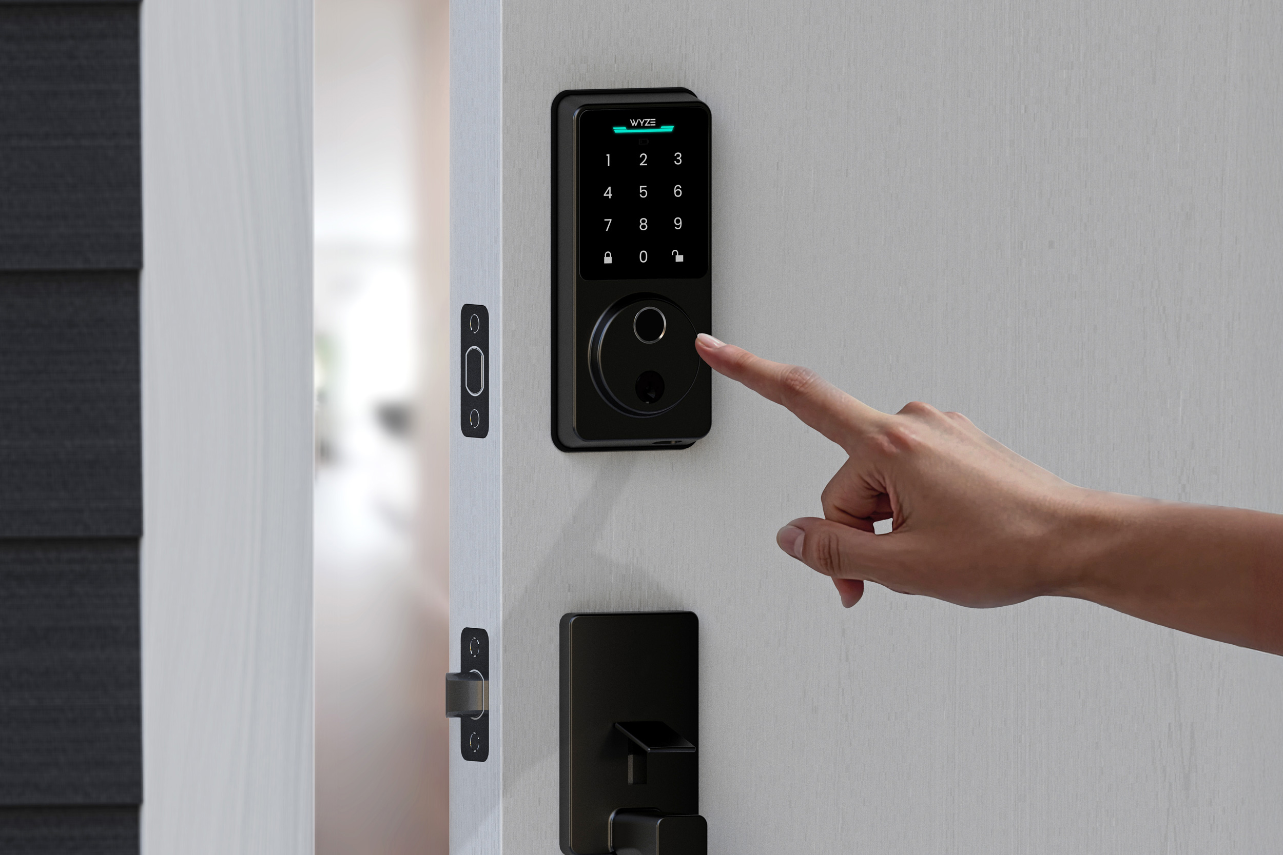 A person is about to use the fingerprint reader on the Wyze Lock Bolt v2.