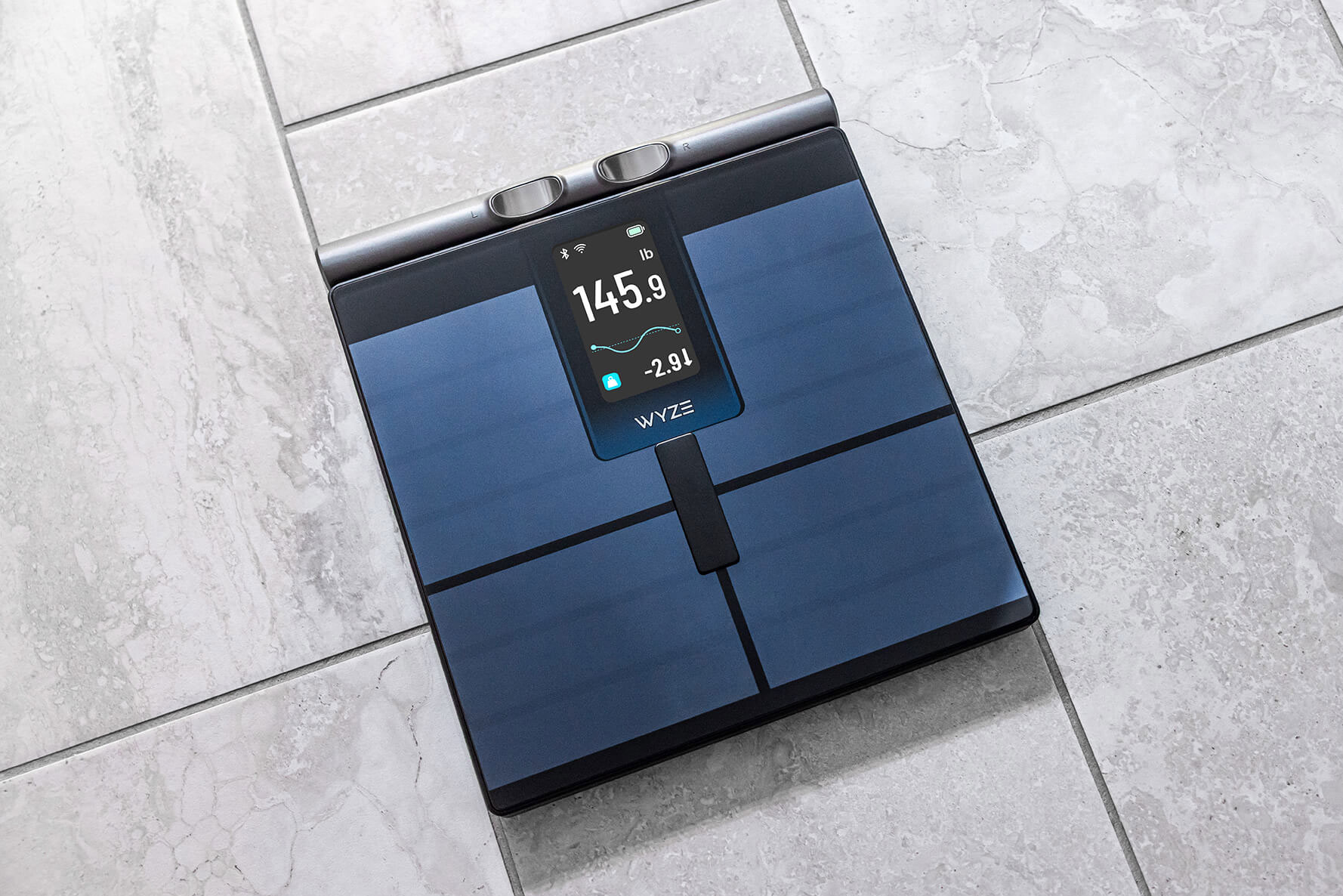 The Wyze Scale Ultra BodyScan sitting on a tile floor with its handle retracted.