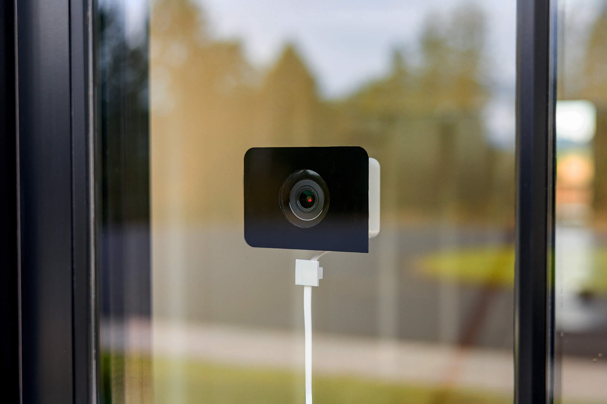 The Wyze Window Cam attached to the inside of a window.