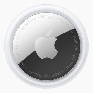 An Apple AirTag on a light gray background.