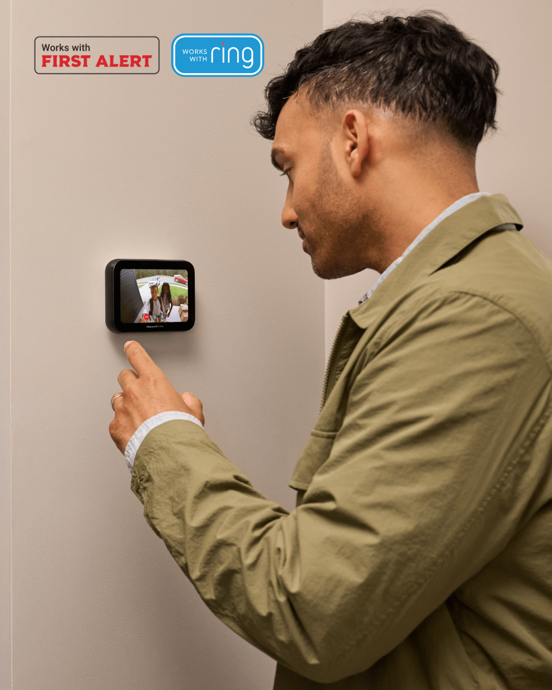 A man looking at a touchscreen thermostat