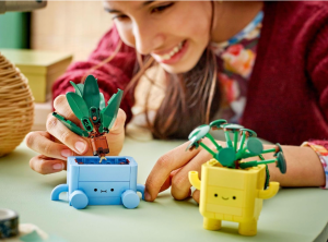 Youngster playing with two lego fake plants