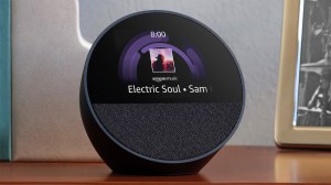 Amazon Echo Spot smat speaker sitting on a table with cover art and title of a song “Electric Soul” playing via Amazon Music.