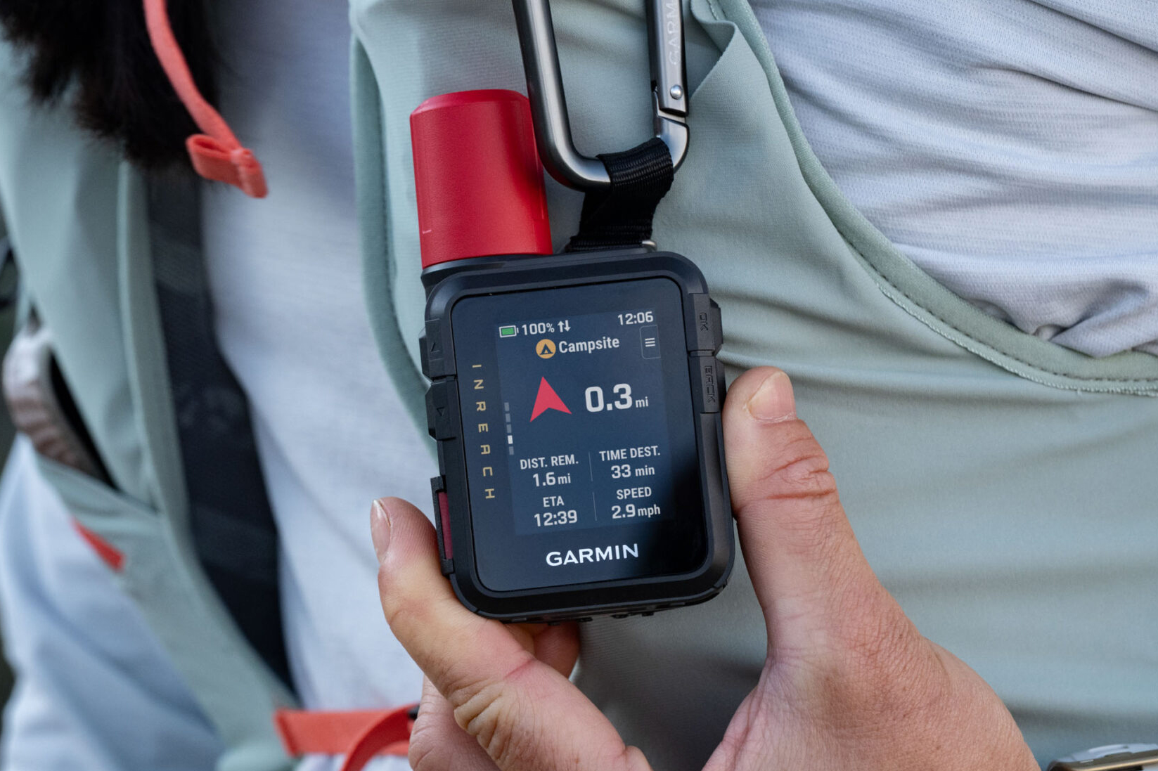 The Garmin inReach Mini 3 Plus satellite communicator hanging from a carabiner.