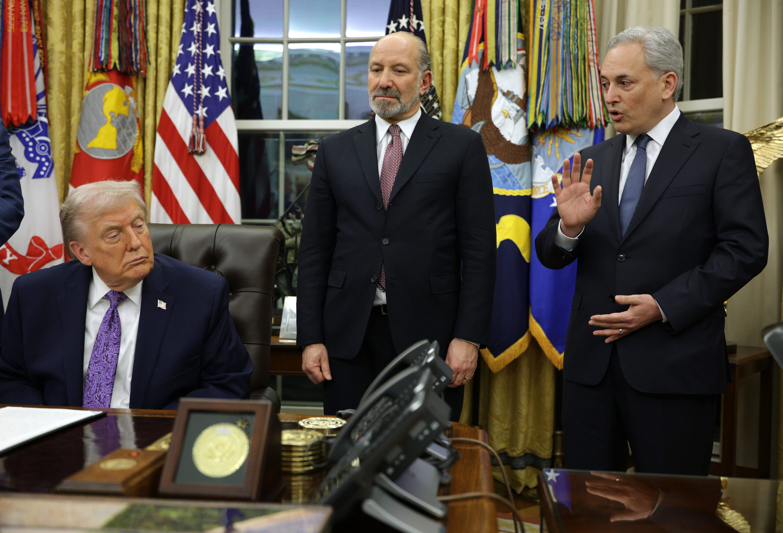 President Donald Trump and Commerce Secretary Howard Lutnick look on as White House artificial intelligence (AI) and crypto czar David Sacks speaks in the Oval Office