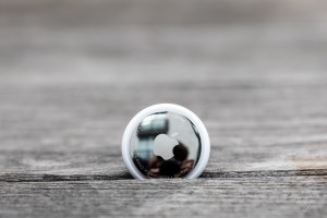 An AirTag wedged into some planks of wood.