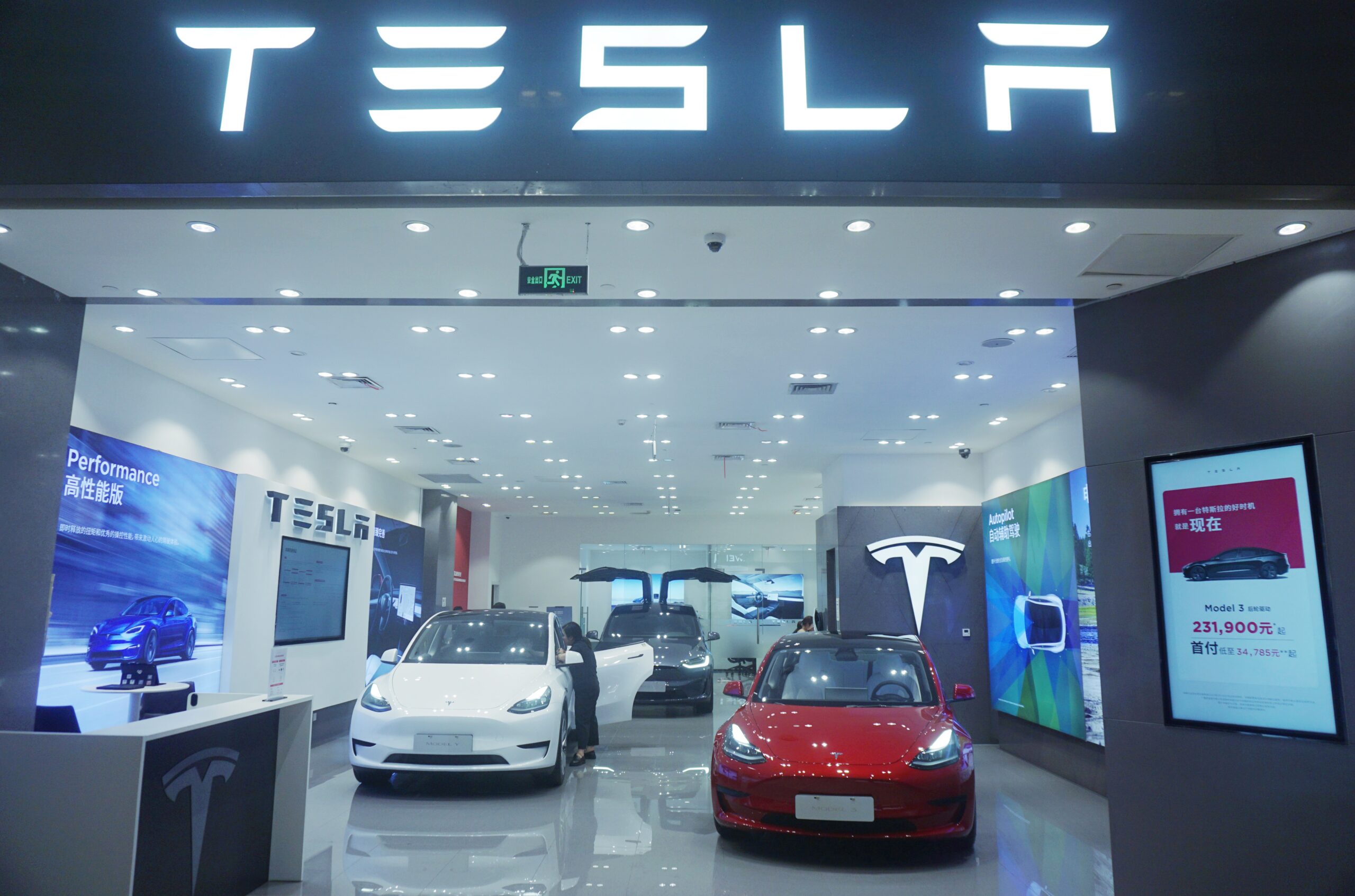 A Tesla storefront with several cars