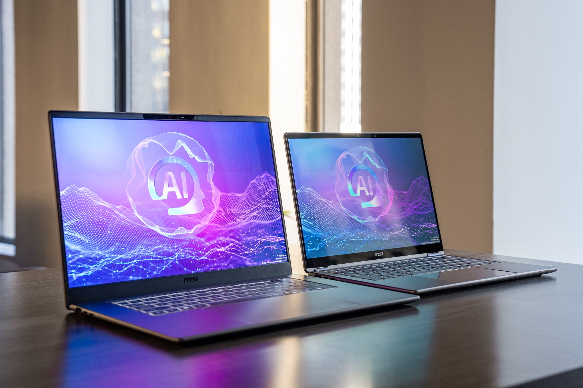 The MSI Prestige 16 Flip AI Plus and Prestige 14 Flip AI Plus laptops side-by-side on a table.