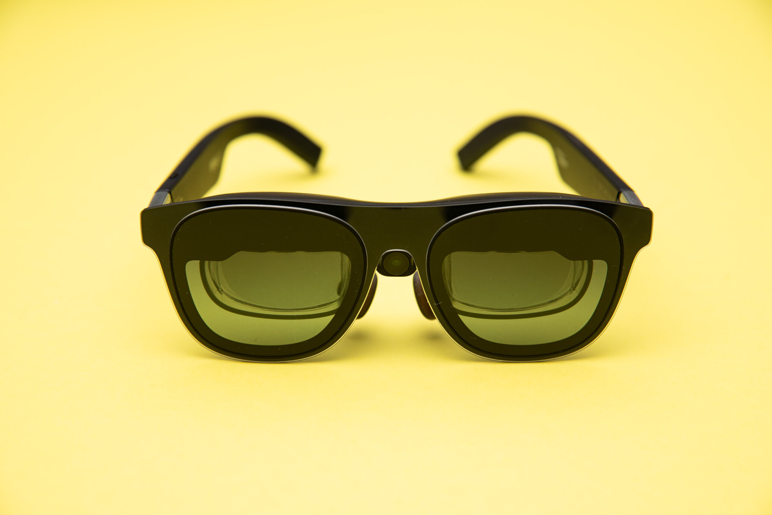 front-view of the Xreal 1S on a colorful yellow background