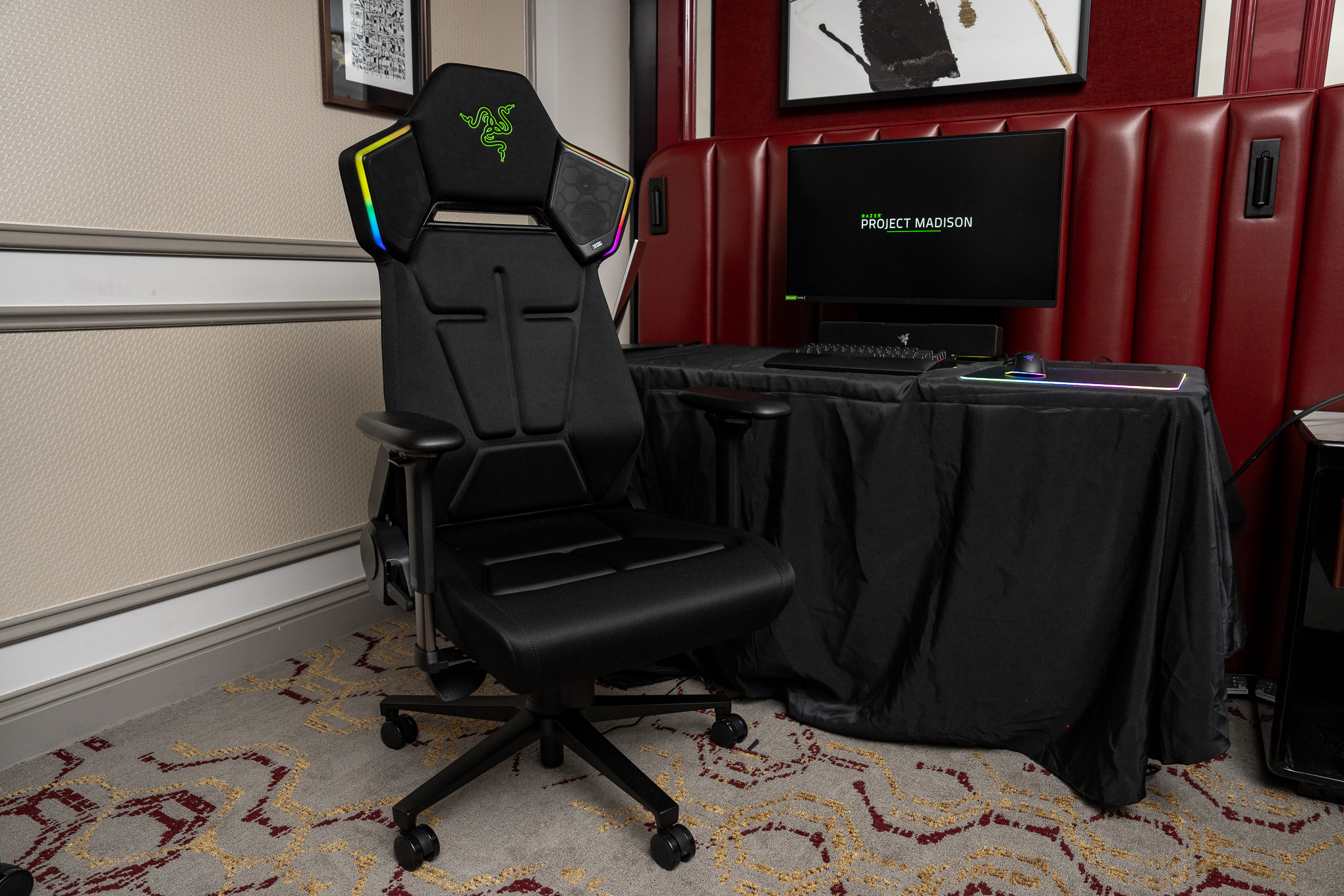 A Razer Project Madison concept gaming chair in front of a table with a keyboard, mouse, and monitor.